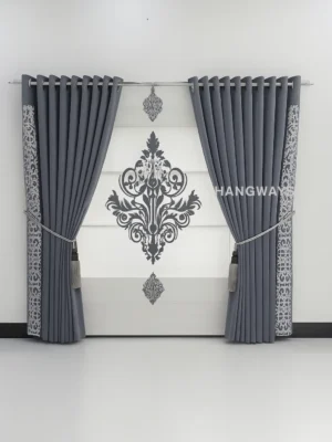 Gray damask curtains with ornate decorative panels and grommet top hanging in modern room